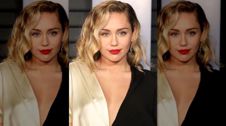 Miley Cyrus on the red carpet with a red lip