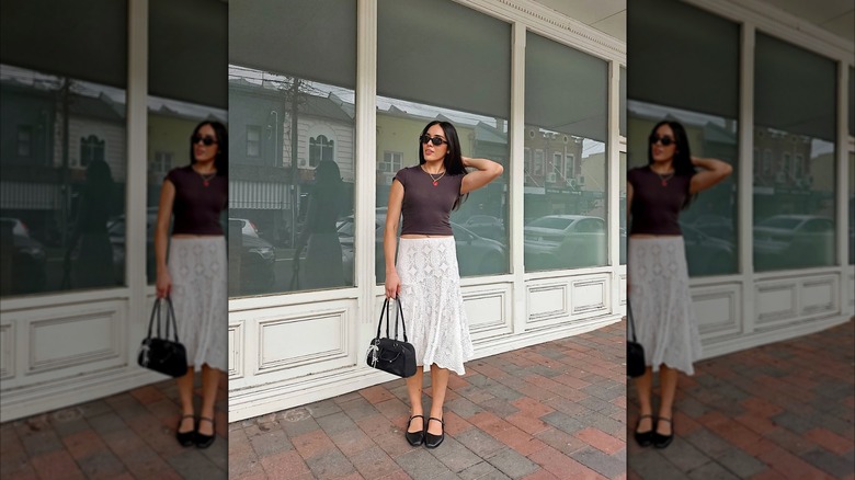 Woman wearing a white midi skirt and black ballet flats