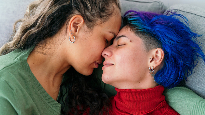 Queer couple embracing each other on a couch