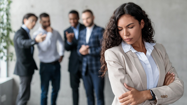 People talking about a woman behind her back