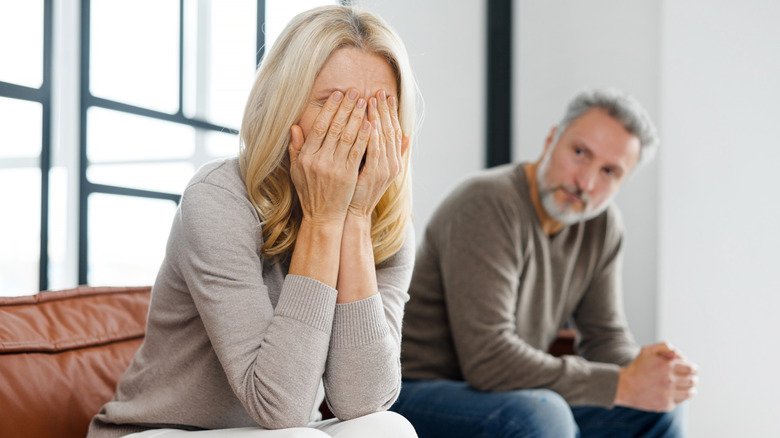 Older man and woman sitting on couch