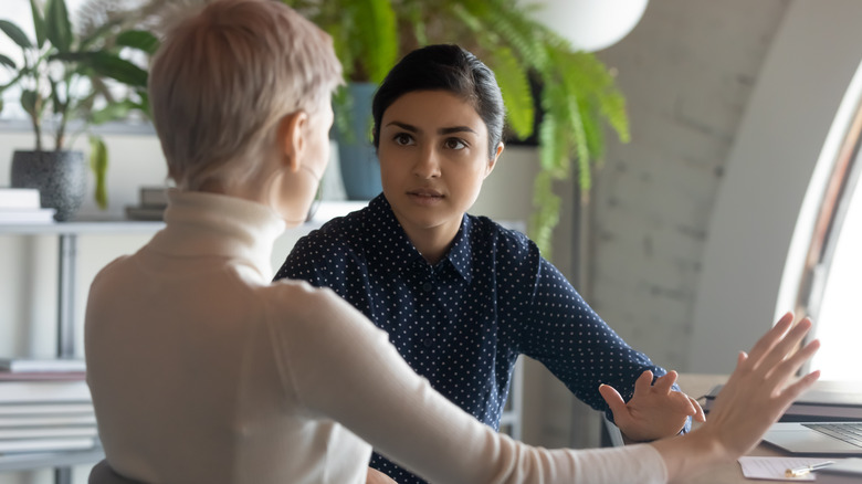 women talking in meeting