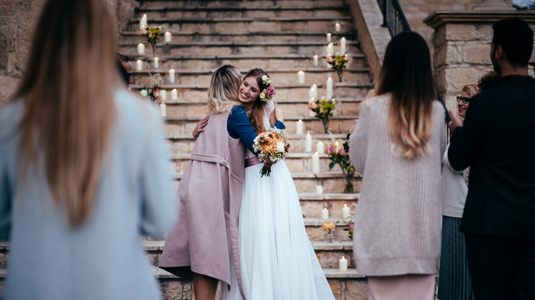 Bride hugging a wedding guest