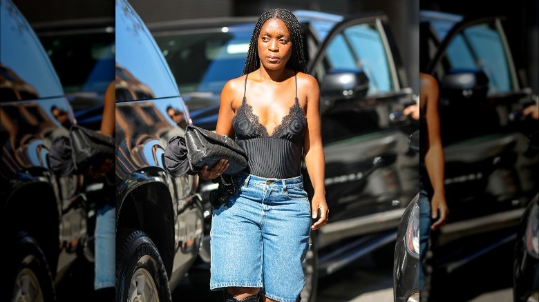 woman wears a lace camisole with jeans 
