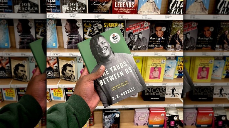 Hand holding "The Yards Between" book