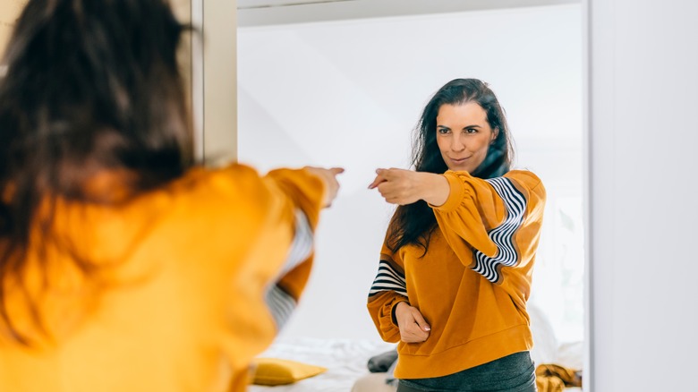 woman pointing at herself