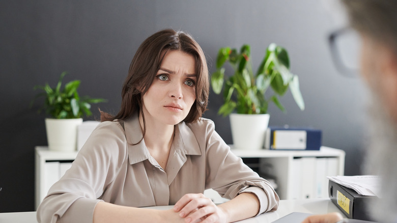 Person with a laptop looking frustrated