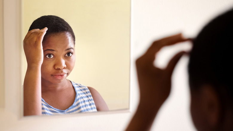 Woman touching her head