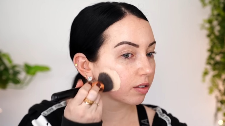 Woman applying foundation