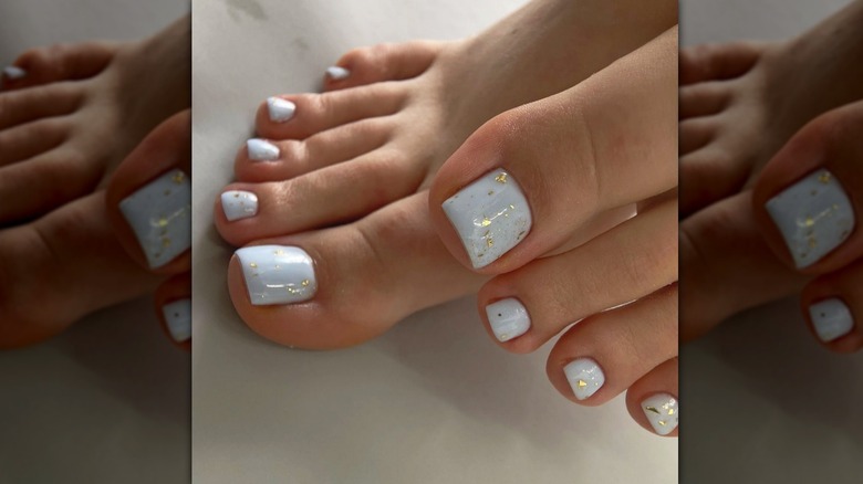 baby blue pastel pedicure with golden flecks