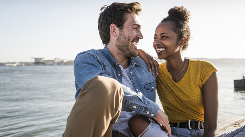 woman and man looking at each other and smiling and laughing