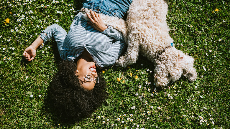 Woman and dog on grass