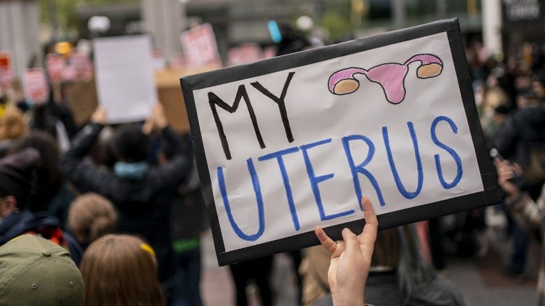 Woman holds abortion access protect sign 