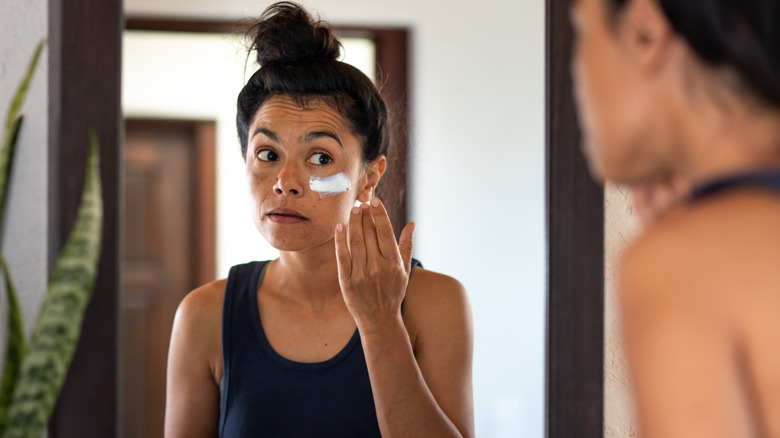 Woman applying sunblock