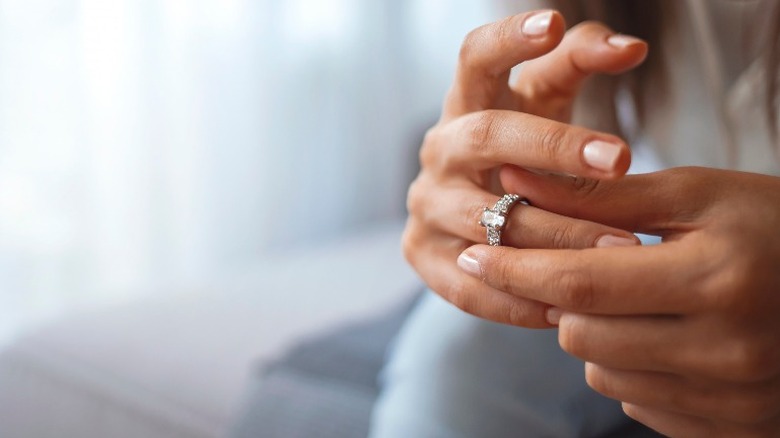 Woman takes off wedding ring