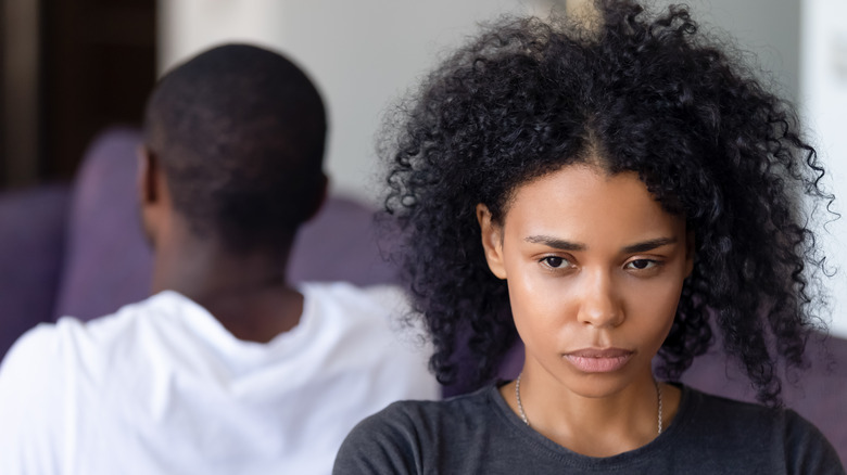 An unhappy couple sitting near each other 