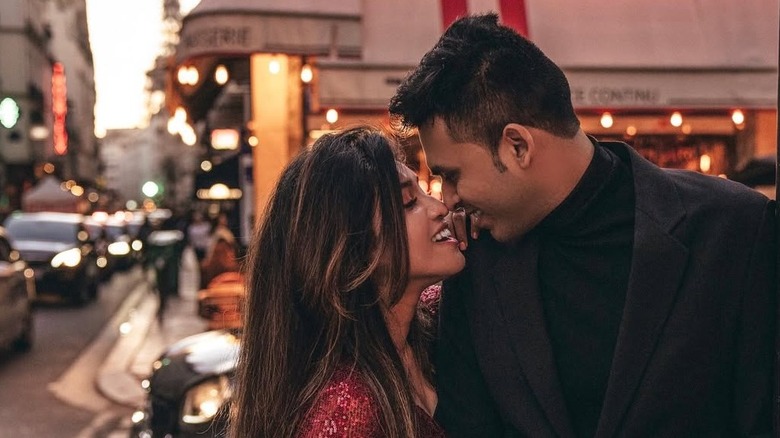 Rumaiza and Anas Ali pose for a photo on a busy street