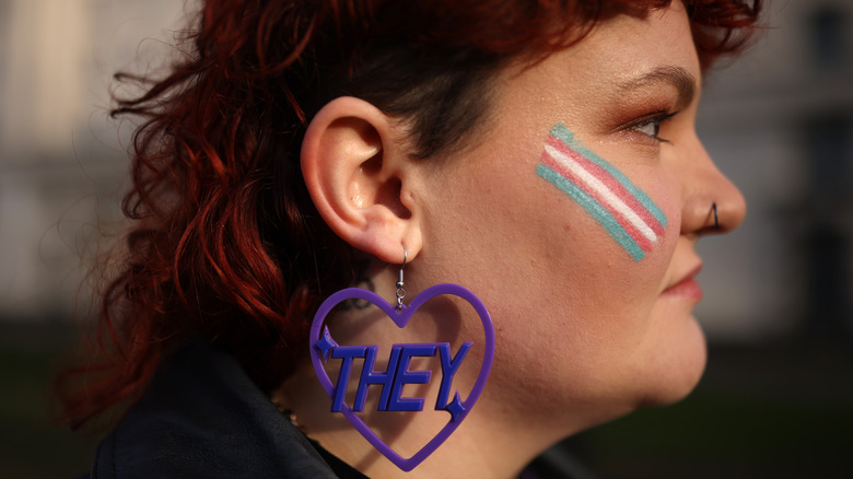 Woman wearing they earrings