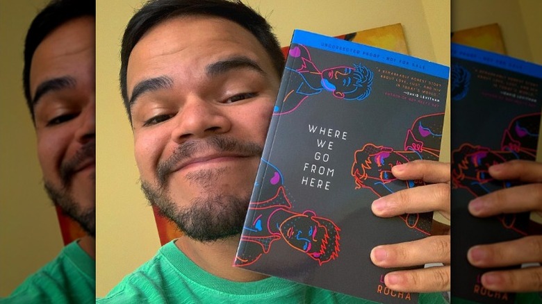 Lucas Rocha holding his book