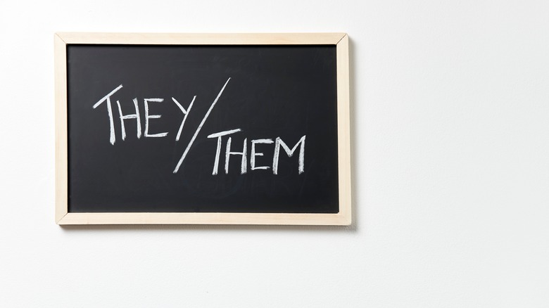 A board with they/them written on it