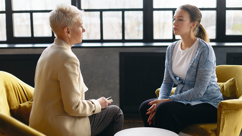 Two women talking, seated