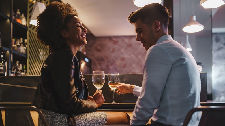 Couple talking, drinking wine