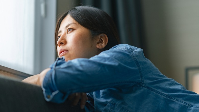 woman looking out window