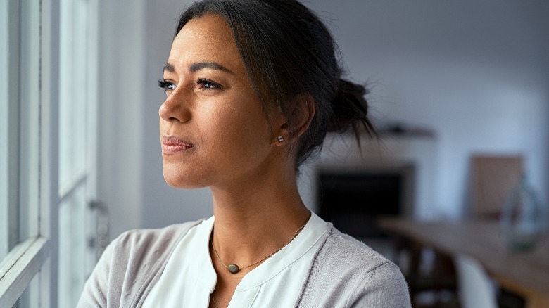 Woman looking out window