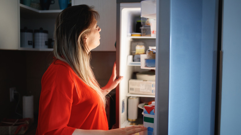 Woman looking in a fridge