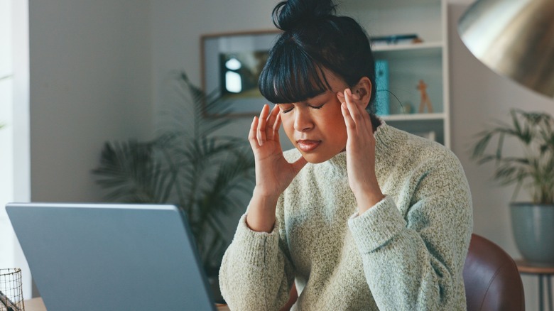 Woman rubbing temples